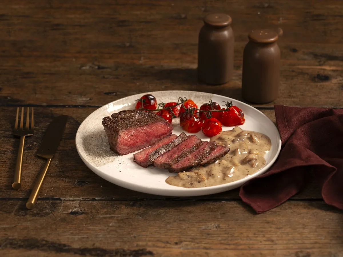A plated steak, sliced.